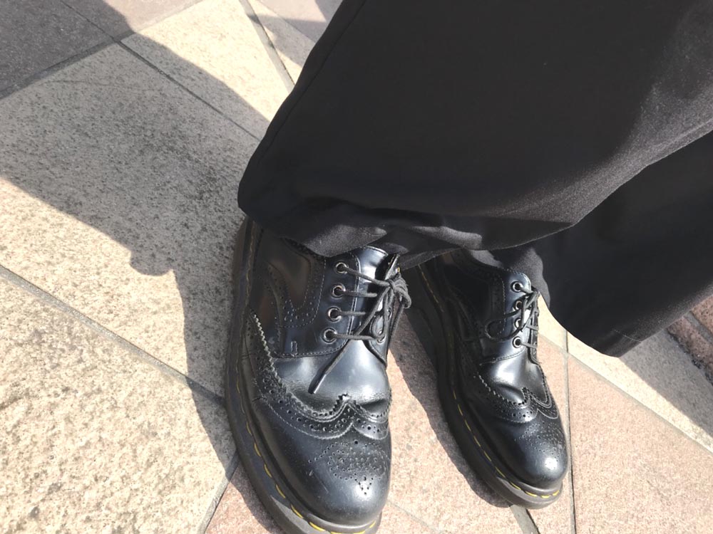 ドクターマーチンの靴を履く男性